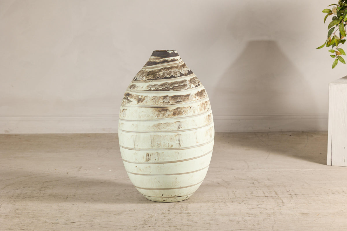 Cream-glazed artisan ceramic vase with brown horizontal bands.
