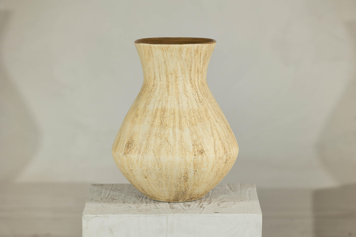Beige ceramic vase with textured drip glaze and flared neck on a square pedestal.