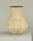 Beige ceramic vase with textured drip glaze and flared neck on a white pedestal.