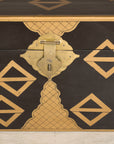 Close-up of chest lock and gold geometric motifs