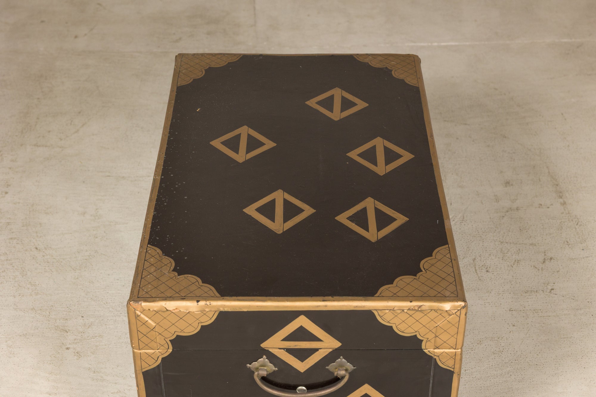 Top view of black lacquered chest with gold decoration