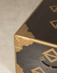 Close-up of black lacquered lid and worn corner
