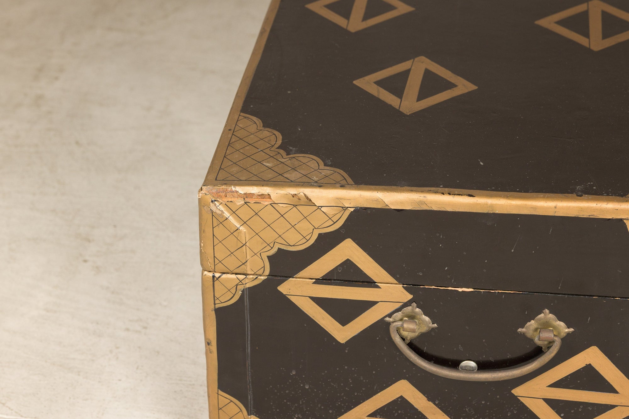 Close-up of lacquered chest corner and carrying handle