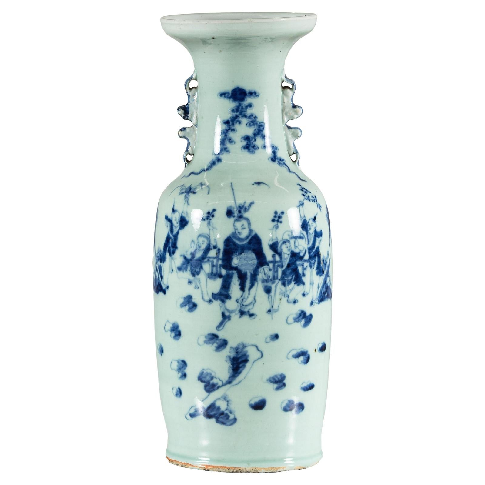 Blue and white porcelain Chinese vase with celadon glaze, cobalt floral and figure scenes, decorative handles, close-up.