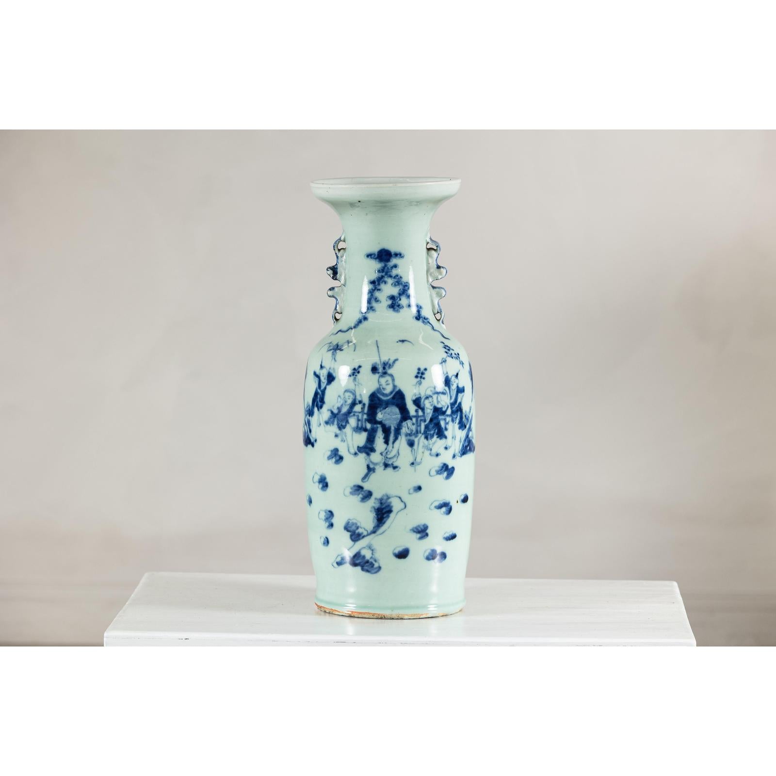 Close-up of blue and white porcelain vase with scenic designs and celadon glaze finish.