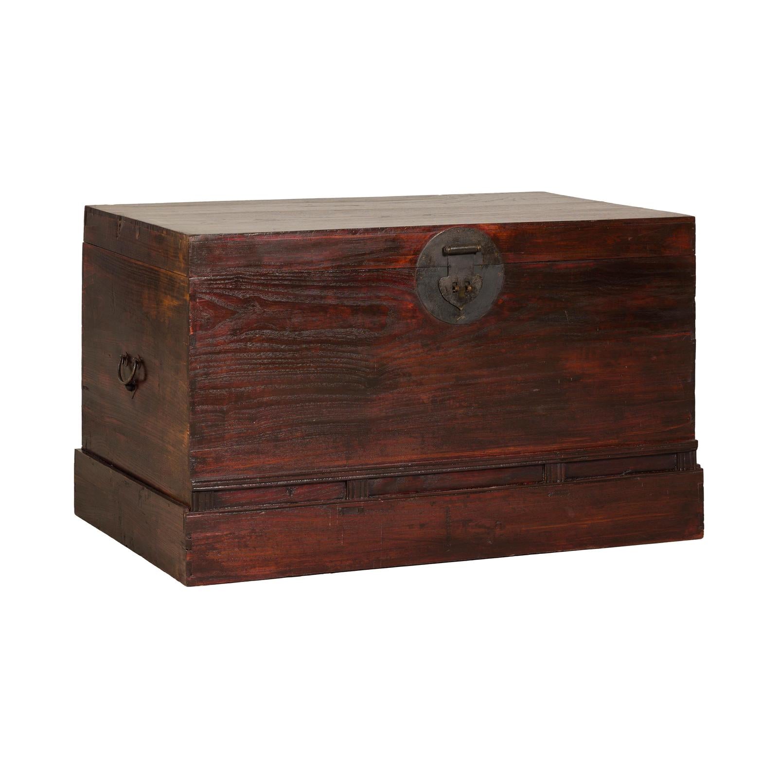 Antique Reddish Brown Lacquered Elm Trunk with Brass Lock and Raised Base