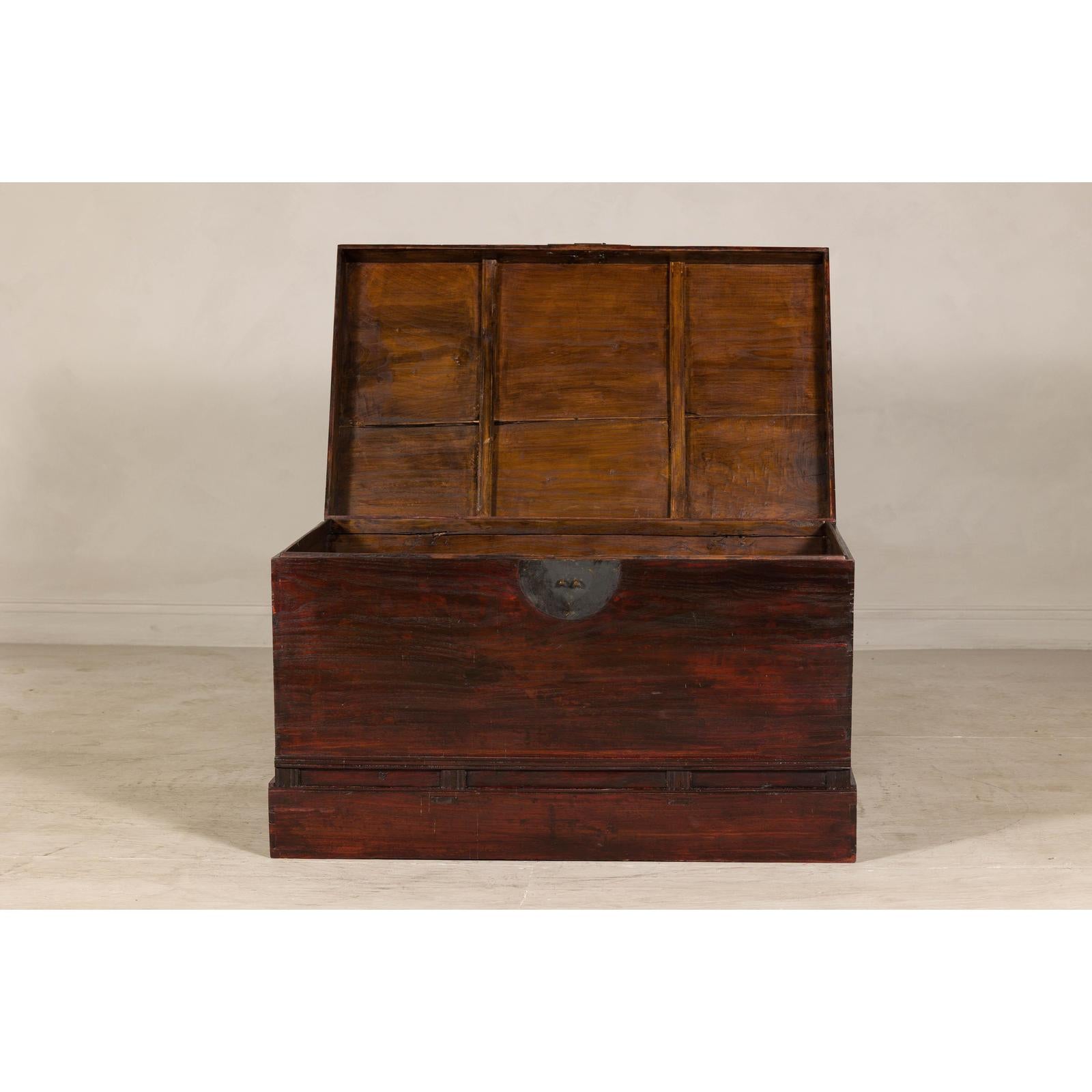 Antique Reddish Brown Lacquered Elm Trunk with Brass Lock and Raised Base