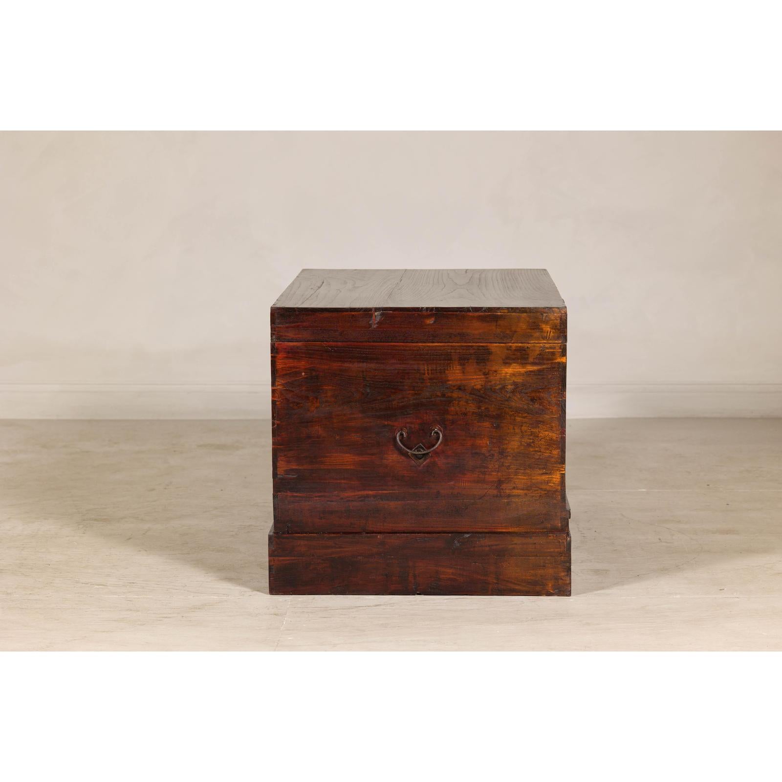 Antique Reddish Brown Lacquered Elm Trunk with Brass Lock and Raised Base