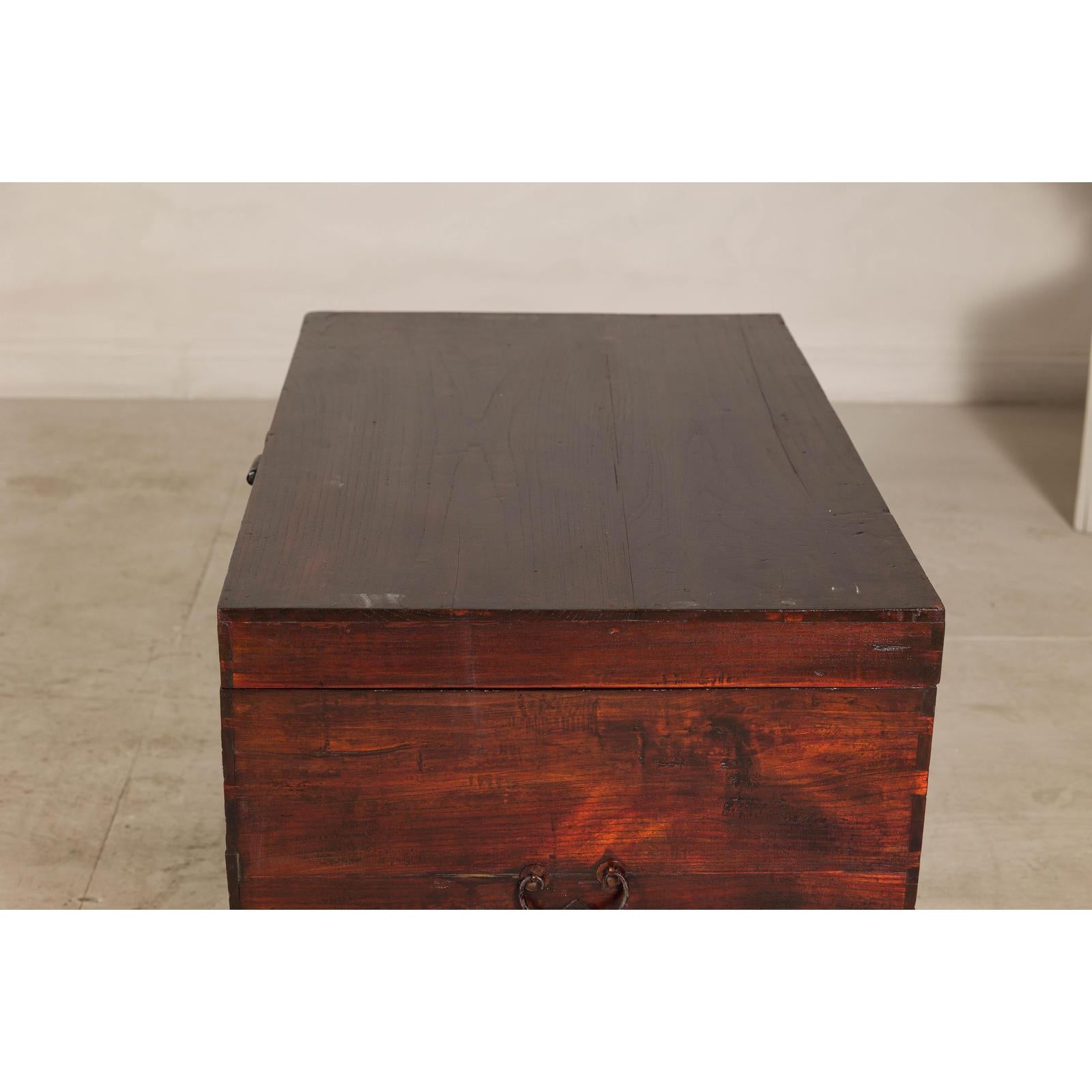 Antique Reddish Brown Lacquered Elm Trunk with Brass Lock and Raised Base