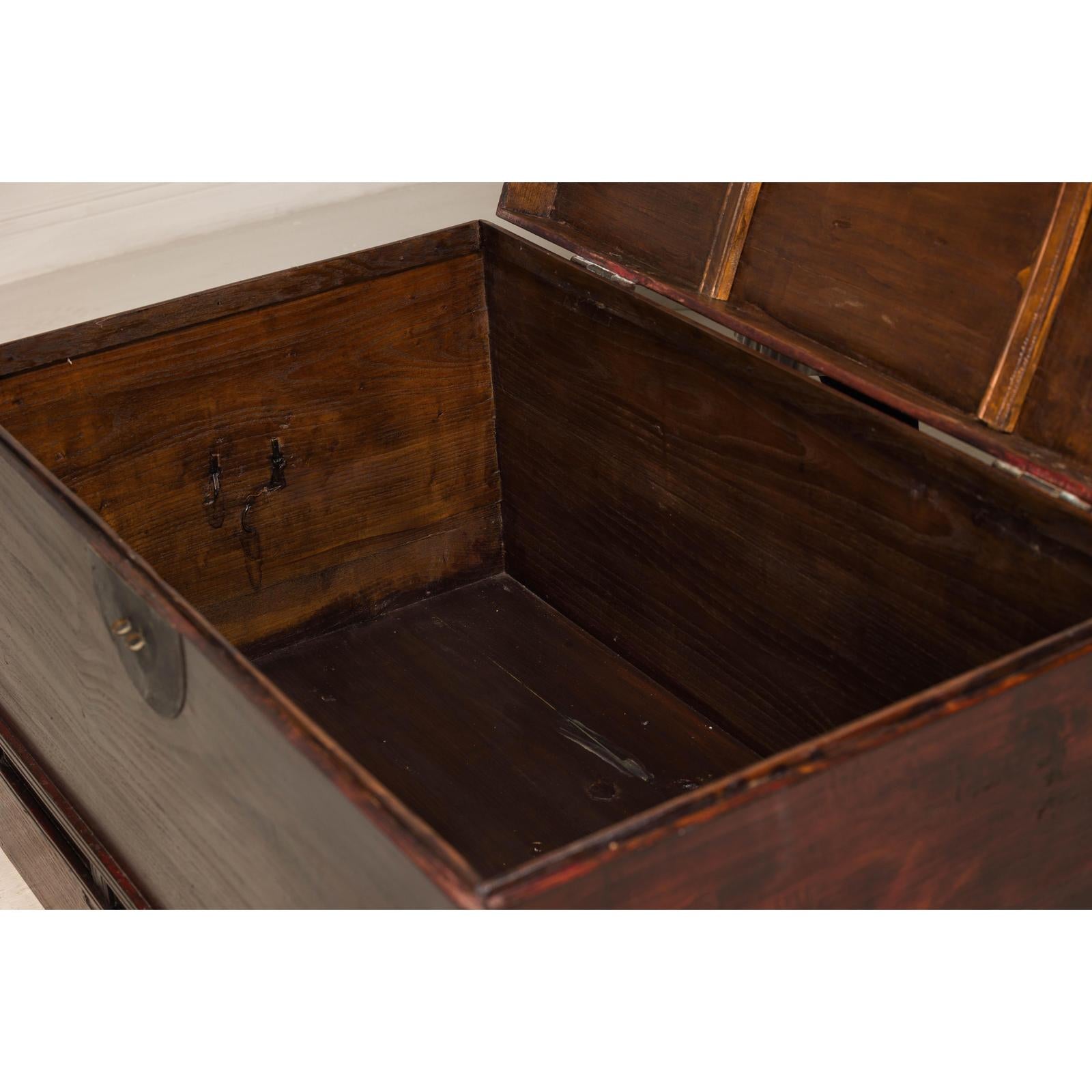Antique Reddish Brown Lacquered Elm Trunk with Brass Lock and Raised Base