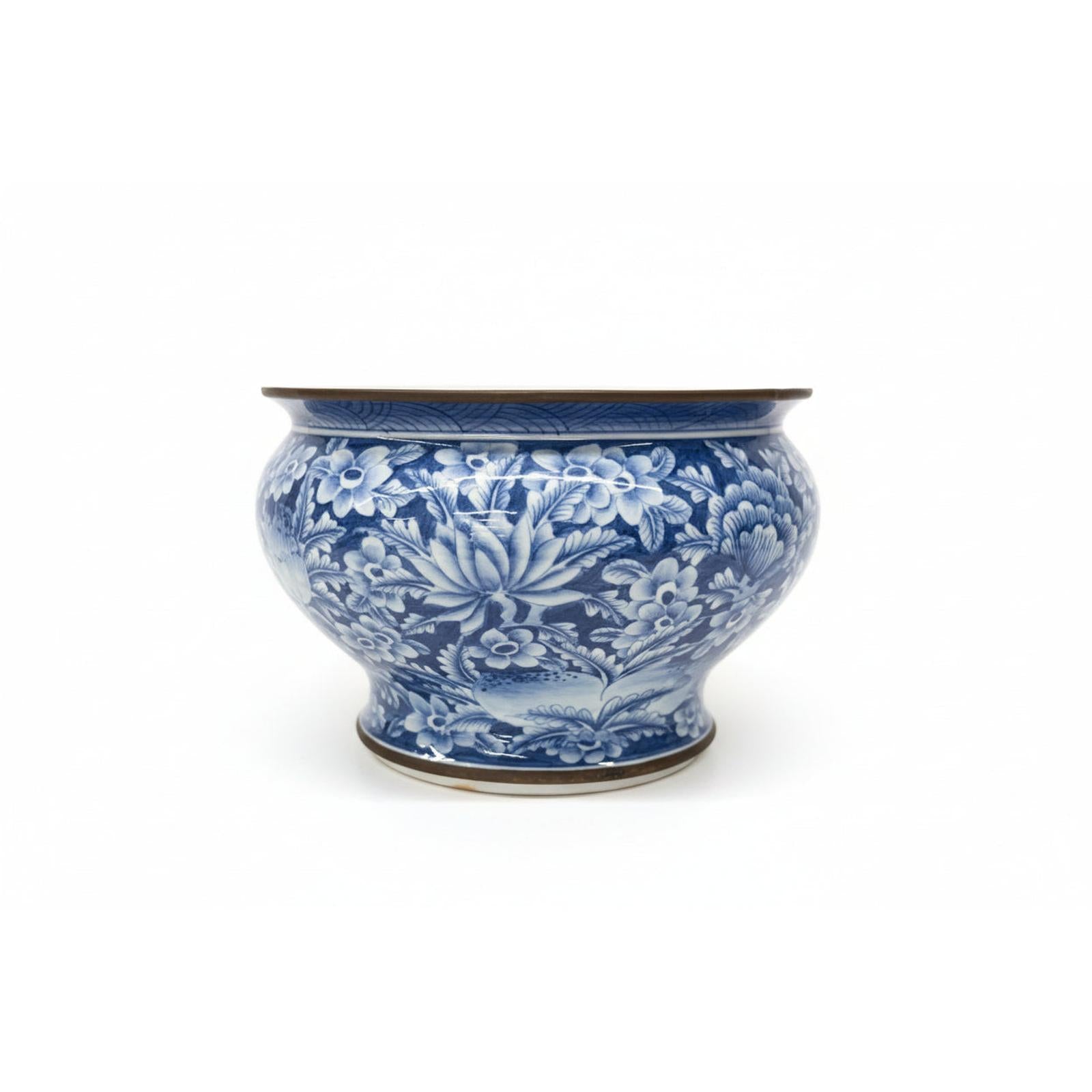 Blue and white ceramic bowl on a stack of books with a blurred bookshelf in the background