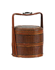 Close-up of brown woven vintage carrying box with double handles, two tiers, and ornate gold designs.
