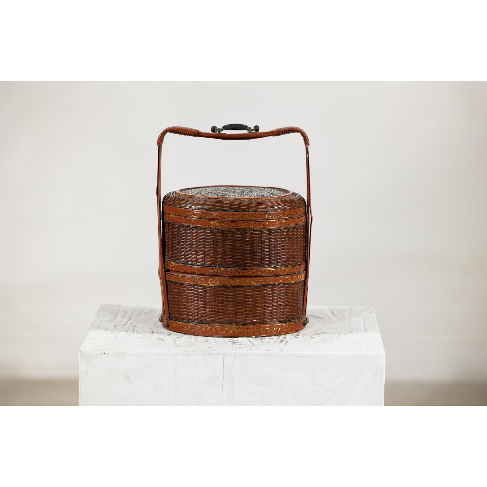 Brown vintage woven carrying box with double handles on a white pedestal, plain background.