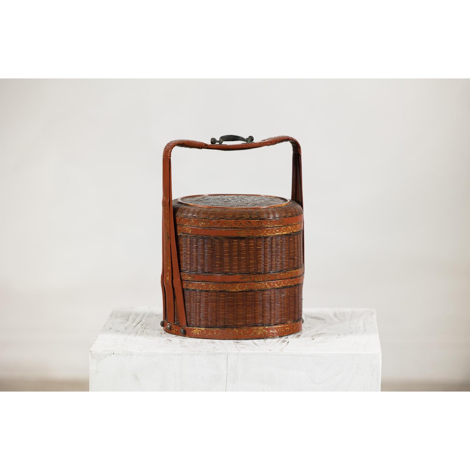 Brown vintage woven carrying box with double handles on a white surface, plain background.