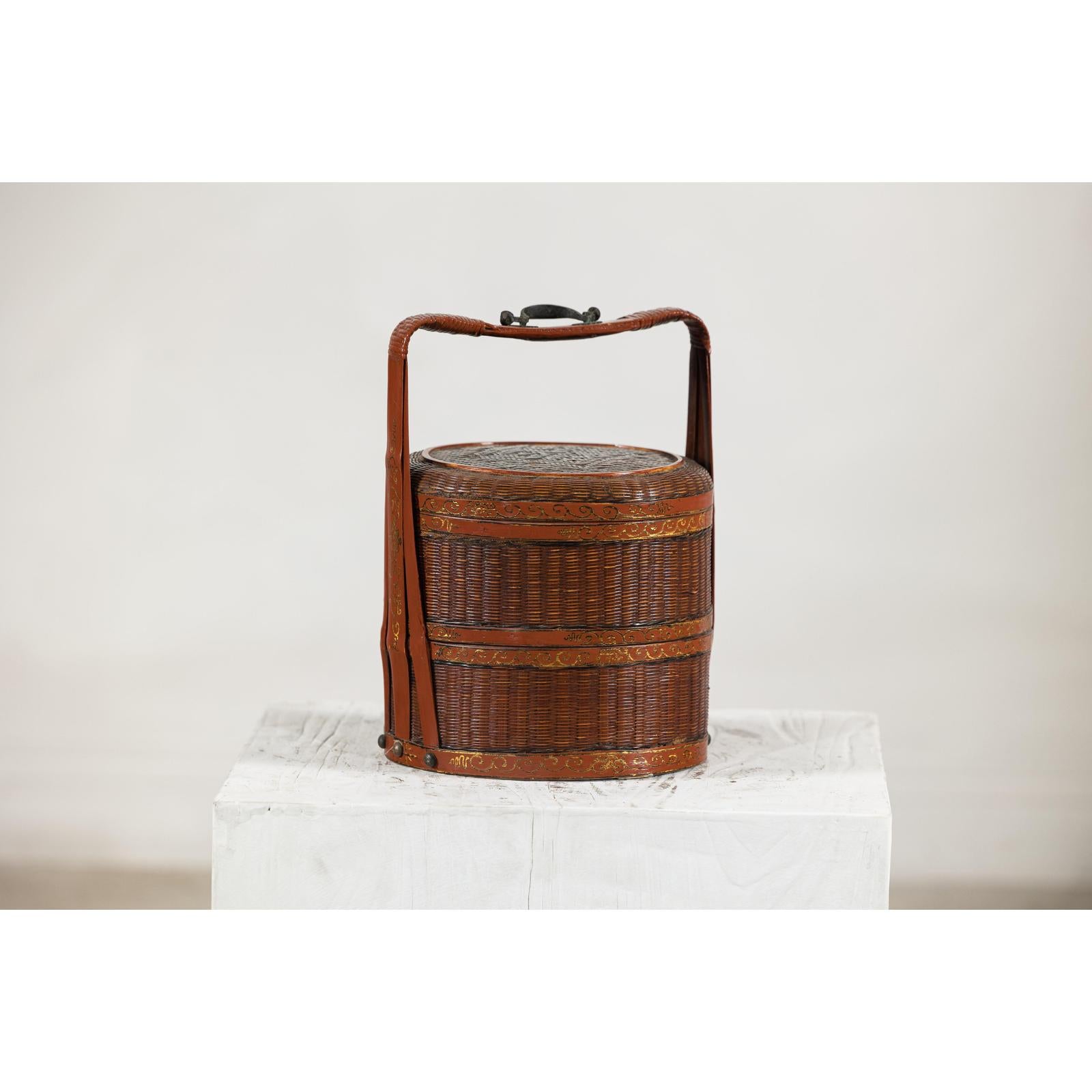 Brown vintage woven box with double handles on white textured pedestal, plain background, close-up.