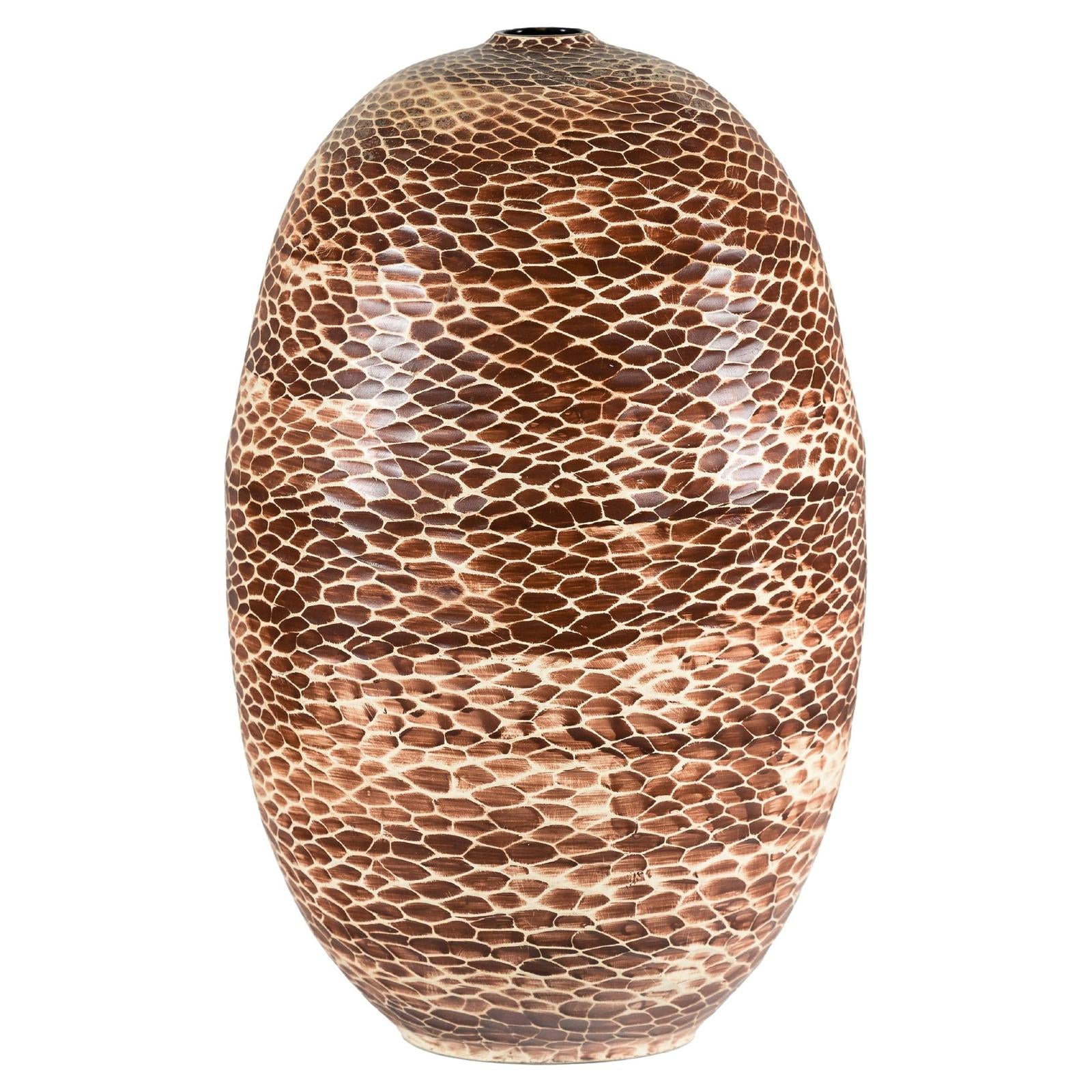 Brown and beige ceramic vase with snakeskin-textured glaze, close-up.