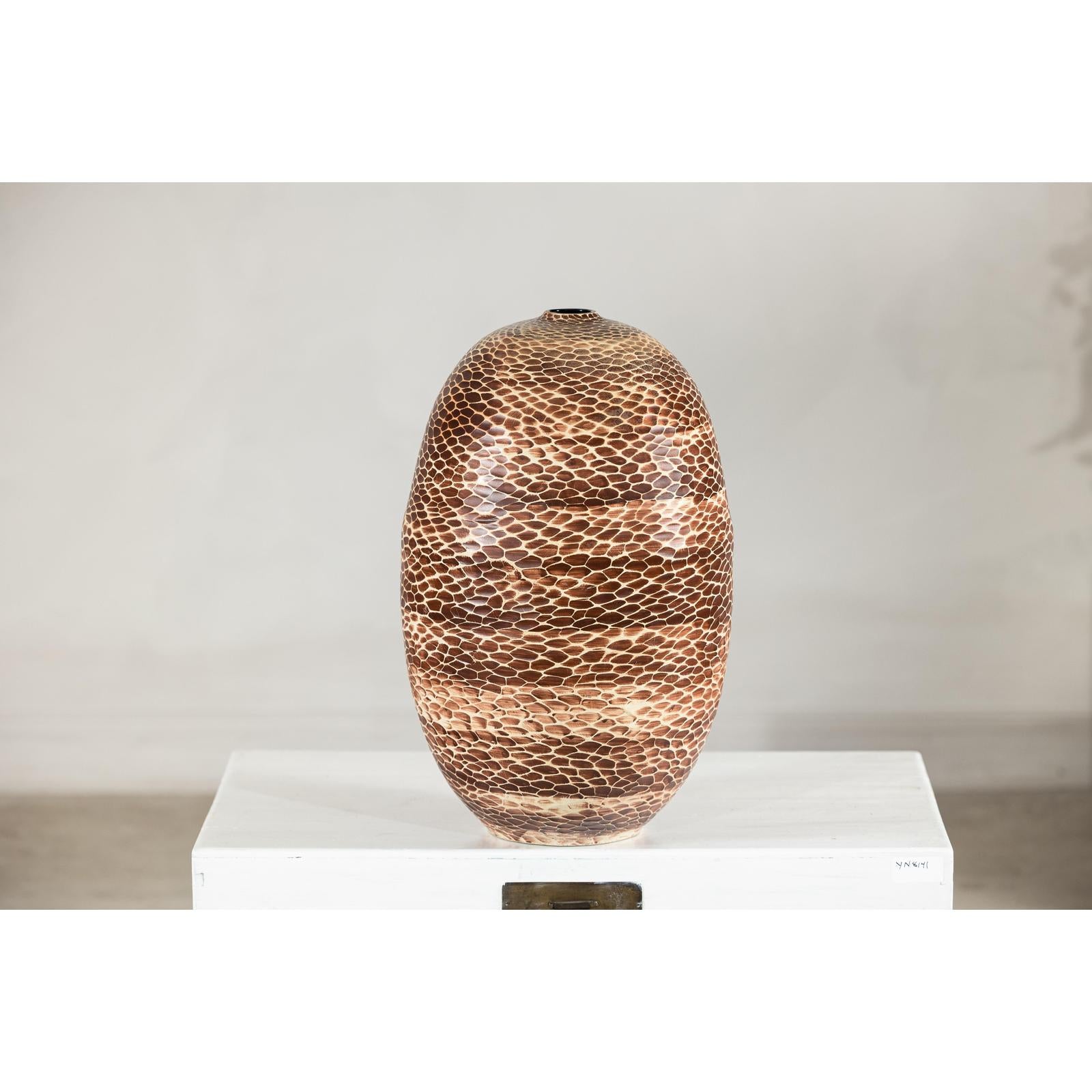 Large ceramic vase with snakeskin textured glaze, neutral tones, displayed on a white pedestal against a plain background.
