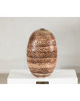 Large ceramic vase with snakeskin textured glaze, neutral tones, displayed on a white pedestal against a plain background.