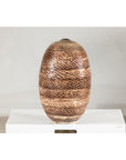 Neutral-toned ceramic vase with snakeskin textured glaze, displayed on white surface against a plain background.