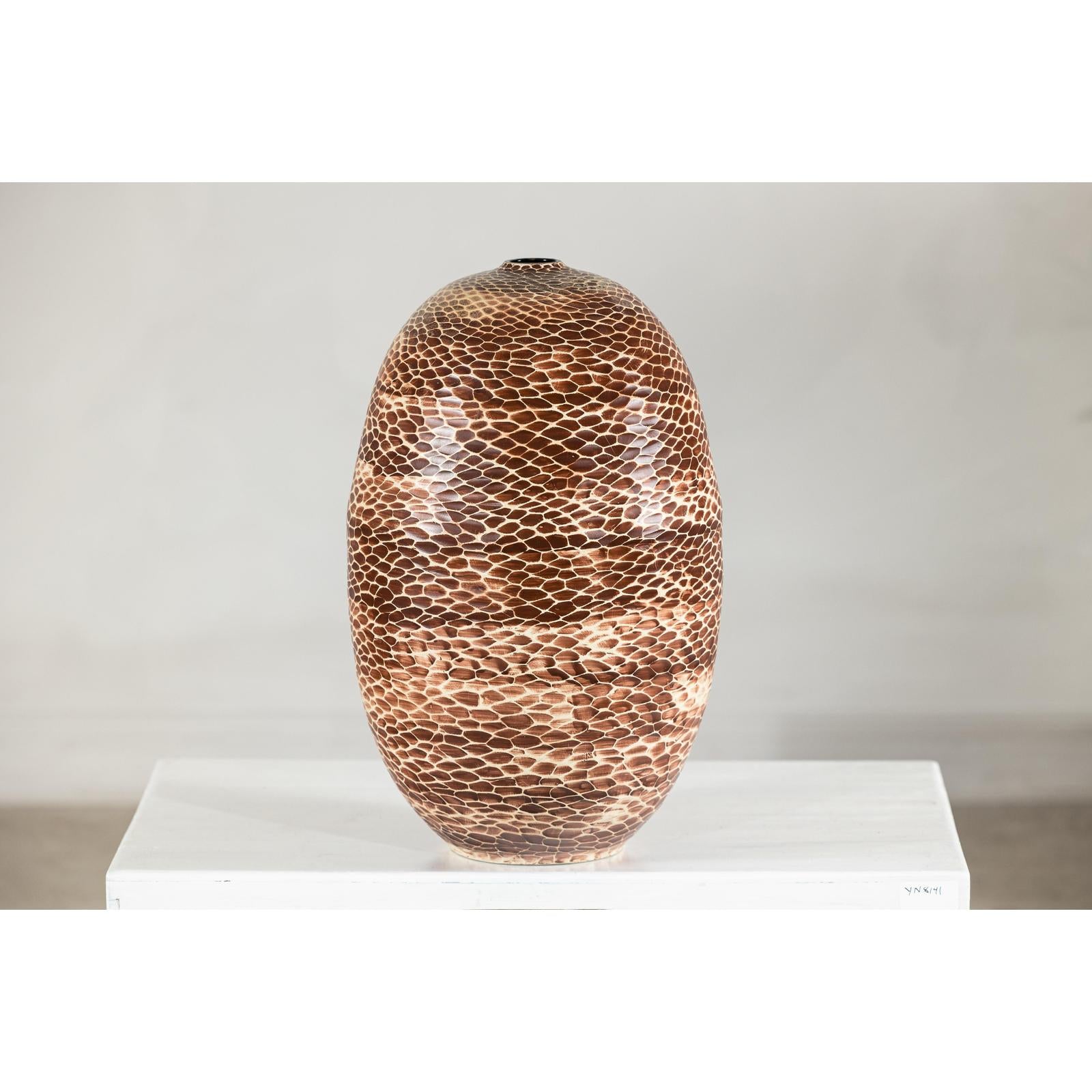Large ceramic vase with snakeskin textured glaze, neutral color, displayed on white pedestal against plain background.