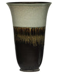 Close-up of a green-grey and brown ceramic planter with drip glaze, flared rim, and textured center pattern.