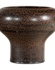 Close-up of a brown speckled ceramic vase with wide mouth, flared base, and textured artisan finish.