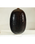 Deep brown and black ceramic vase with honeycomb-textured, scale-like surface against a white background.