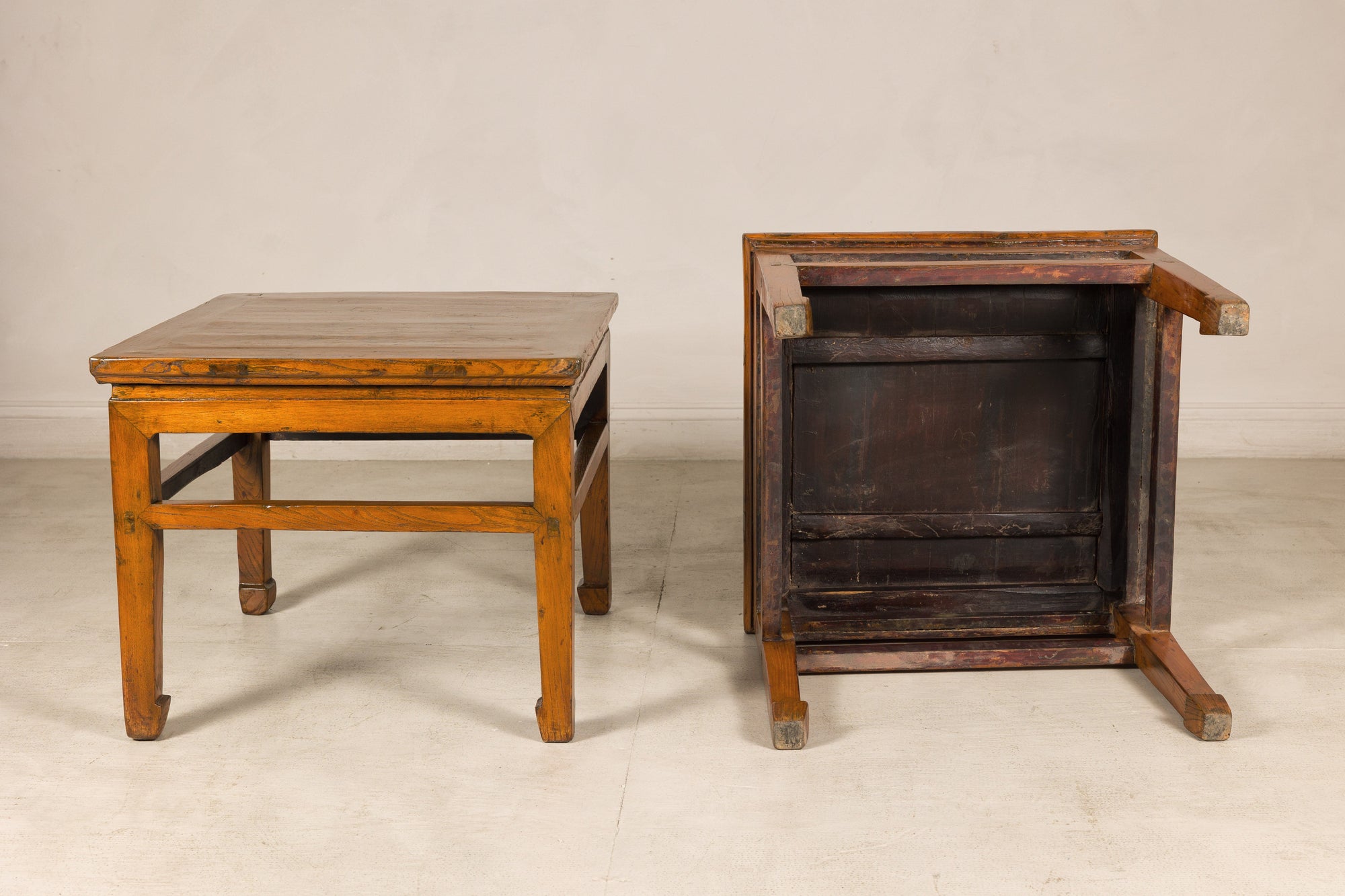 One elm side table upright and one overturned showing underside