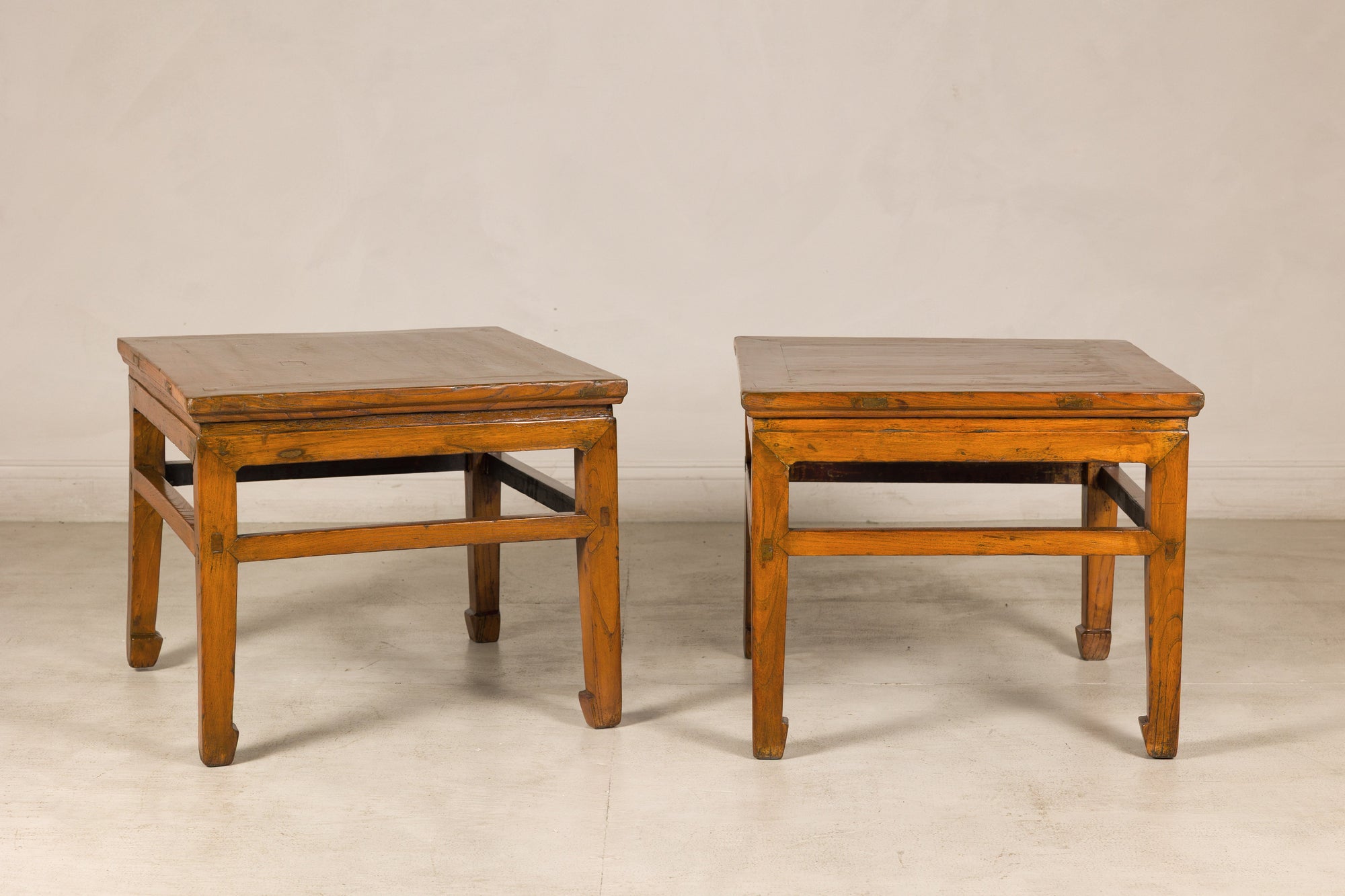 Pair of Chinese elm side tables, three-quarter view
