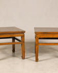 Pair of Chinese elm side tables, three-quarter view