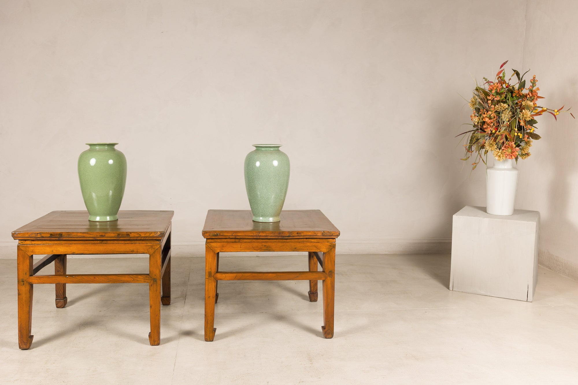 Pair of Qing dynasty elm side tables styled with celadon vases