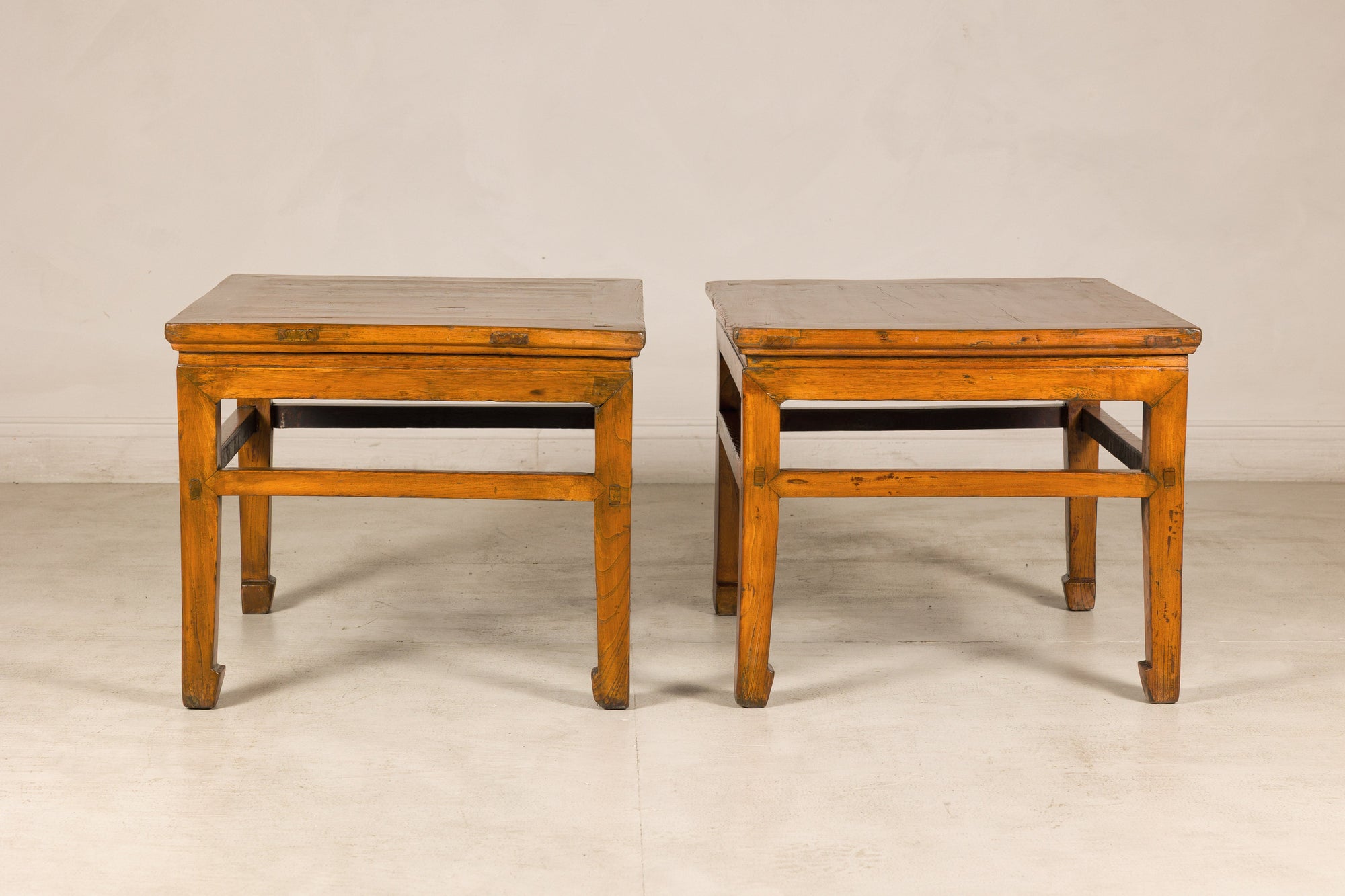 Pair of elm side tables with scalloped aprons, front view