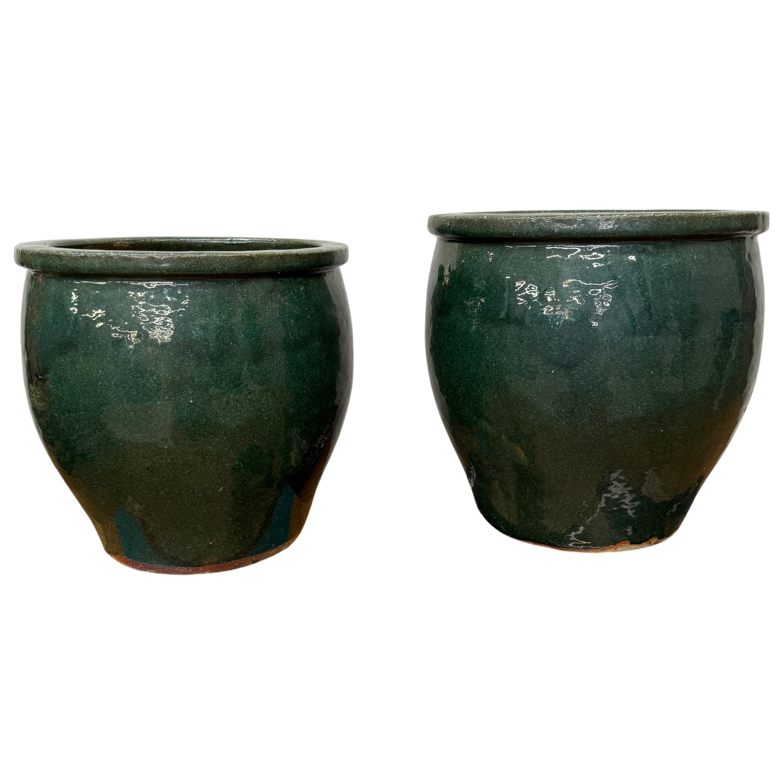 Two dark green ceramic pots on a white background