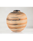 Close-up of round ceramic vase with swirled earth-tone design on white surface, plain background.