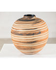 Earth-tone ceramic vase with swirled pattern, round shape, close-up on white surface.