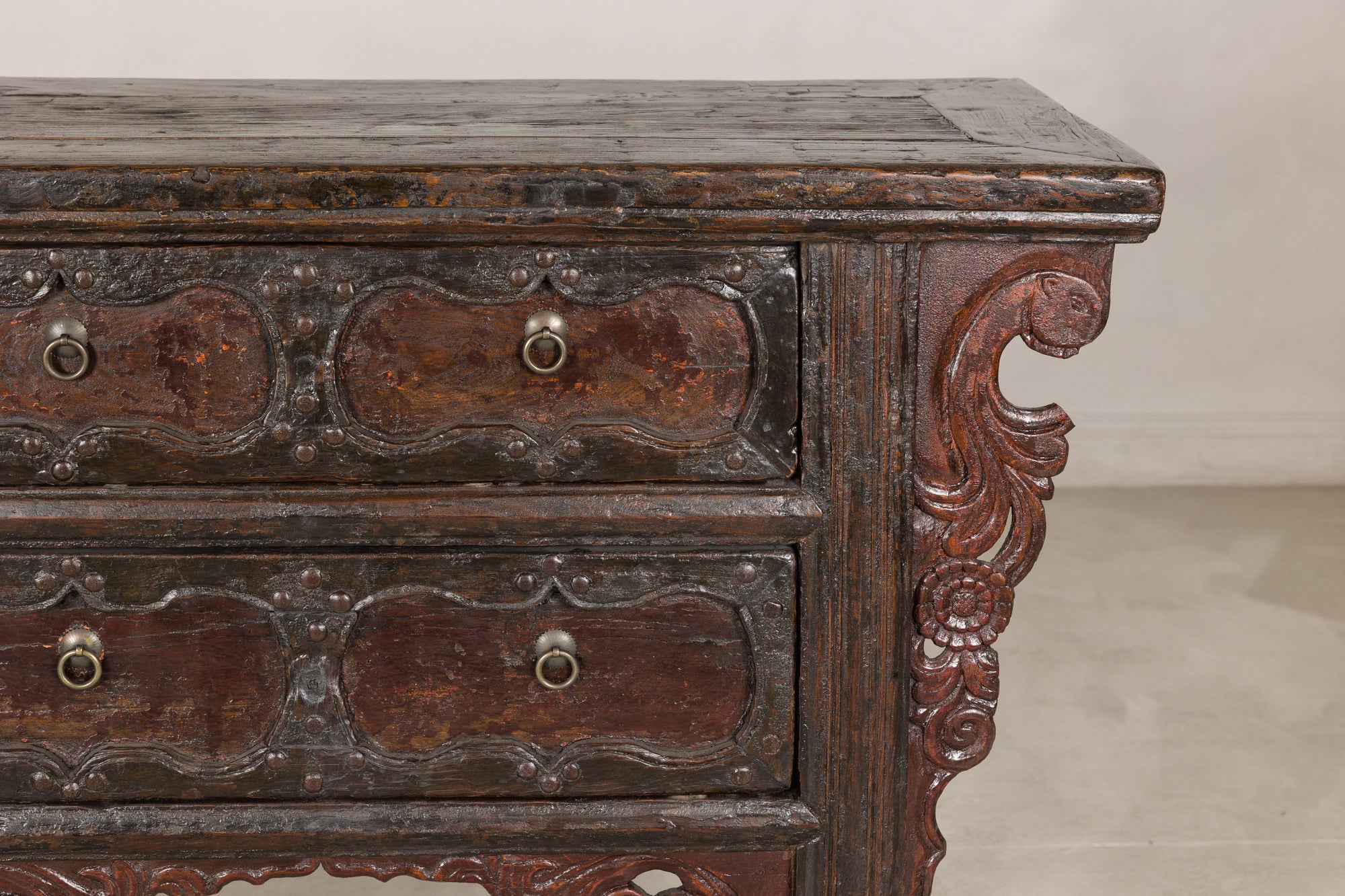 Close-up of cabinet top, drawers and carved side