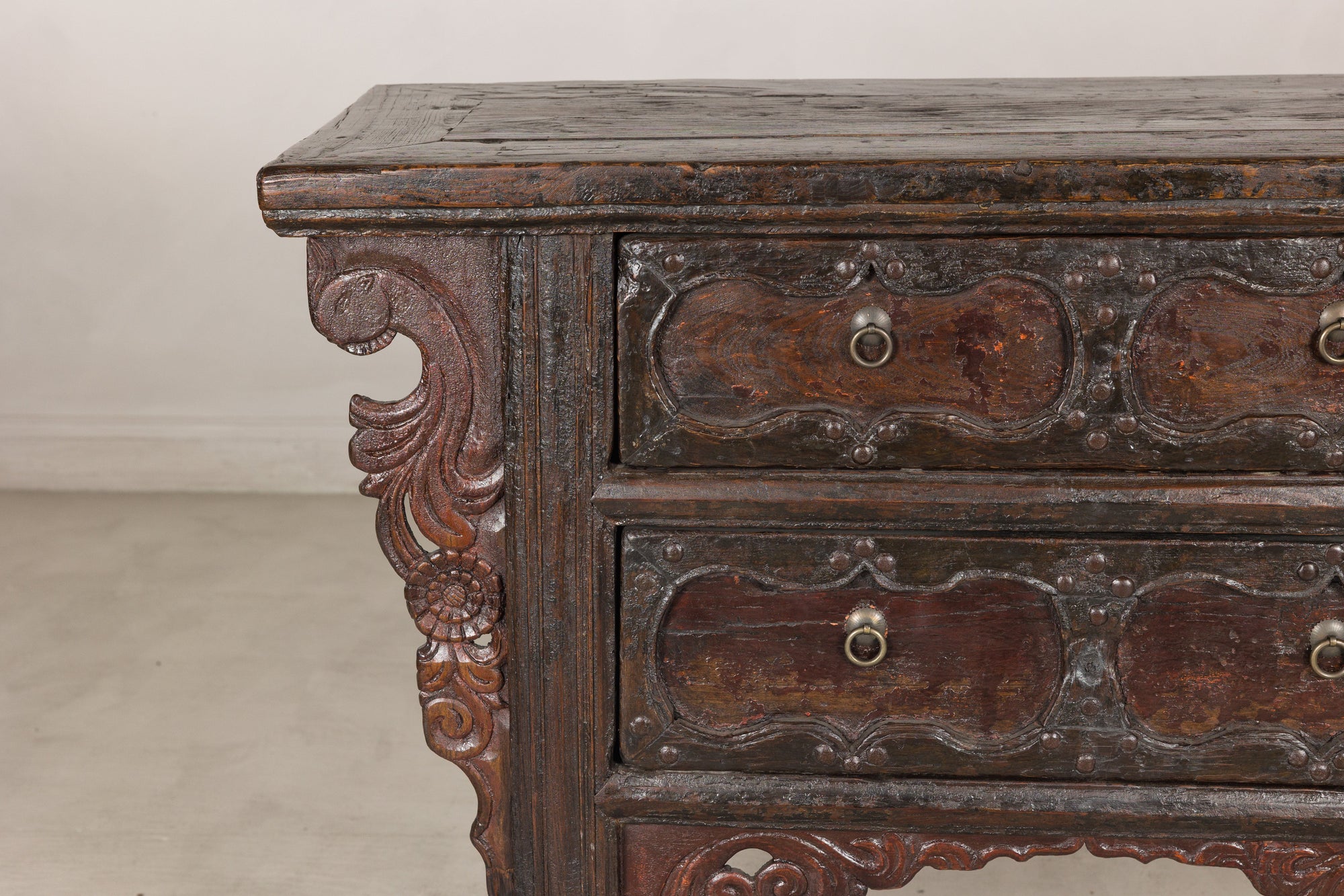 Close-up of cabinet drawers and scrolling bracket
