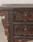 Close-up of cabinet drawers and scrolling bracket