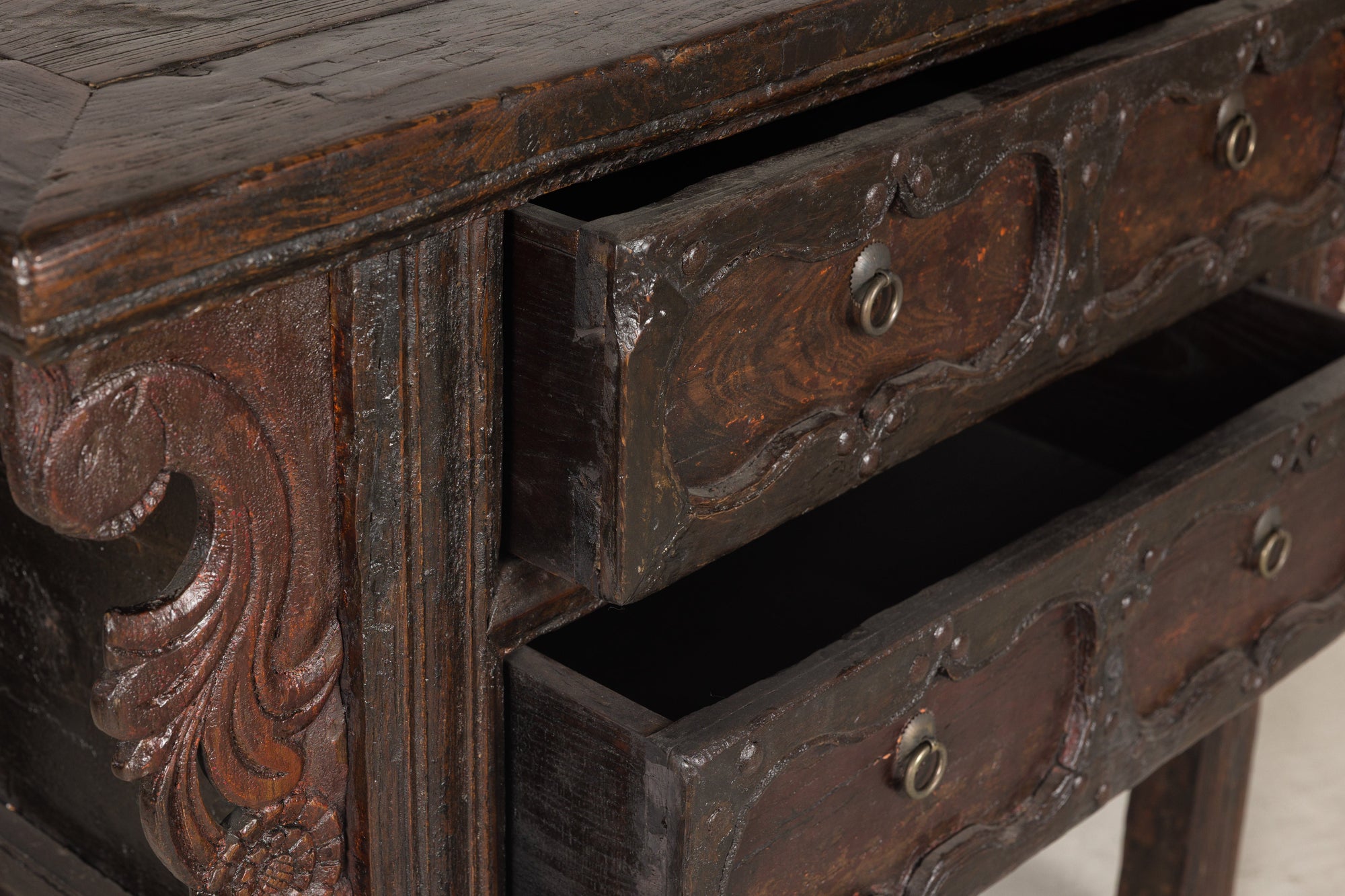 Carved wood cabinet with drawers open