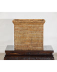 Brown rattan storage box with side handles on a dark wooden table against a white background.