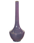 Purple ceramic vase with tall slender neck and glossy finish, sculptural decor on white background.