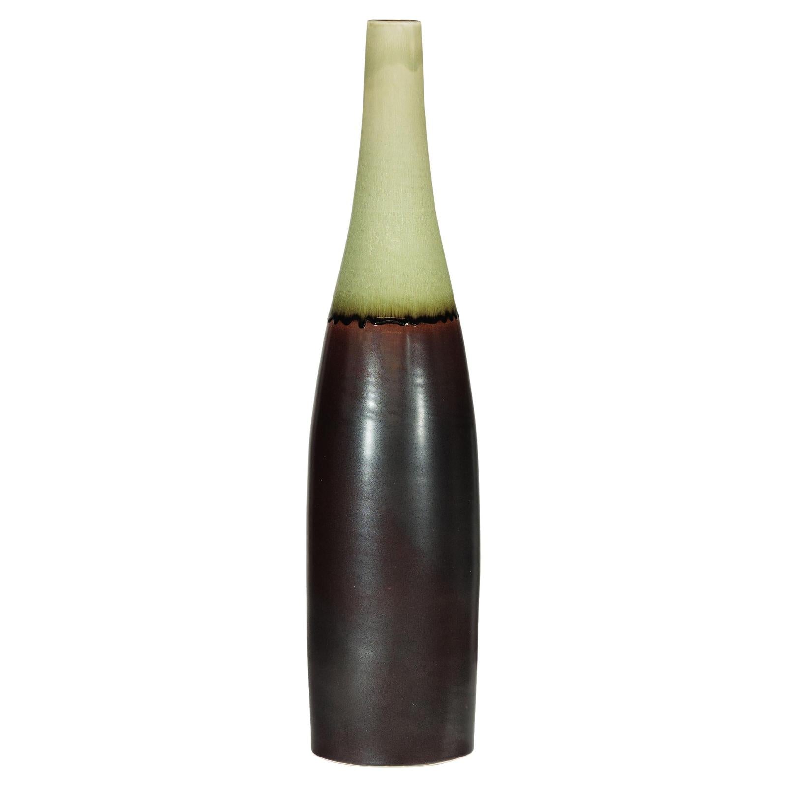 Charcoal ceramic vase with moss green glazed neck, bottle silhouette, artisan finish, close-up.