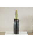 Charcoal ceramic vase with moss green glazed neck on white pedestal, light background, close-up view.