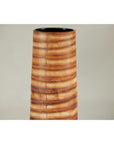 Close-up of tall orange-brown ceramic vase with swirling patterns, handcrafted in a sleek cylindrical shape.