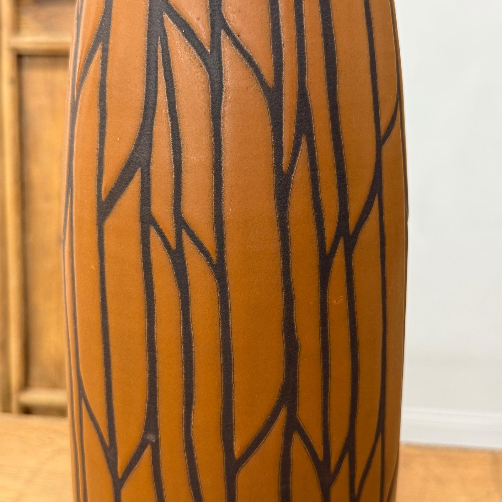 Brown-orange sand ceramic vase with matte finish and black crackle pattern, standing upright.