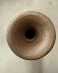 Top view of orange wooden vase with black swirl, hollow cylinder and smooth opening.