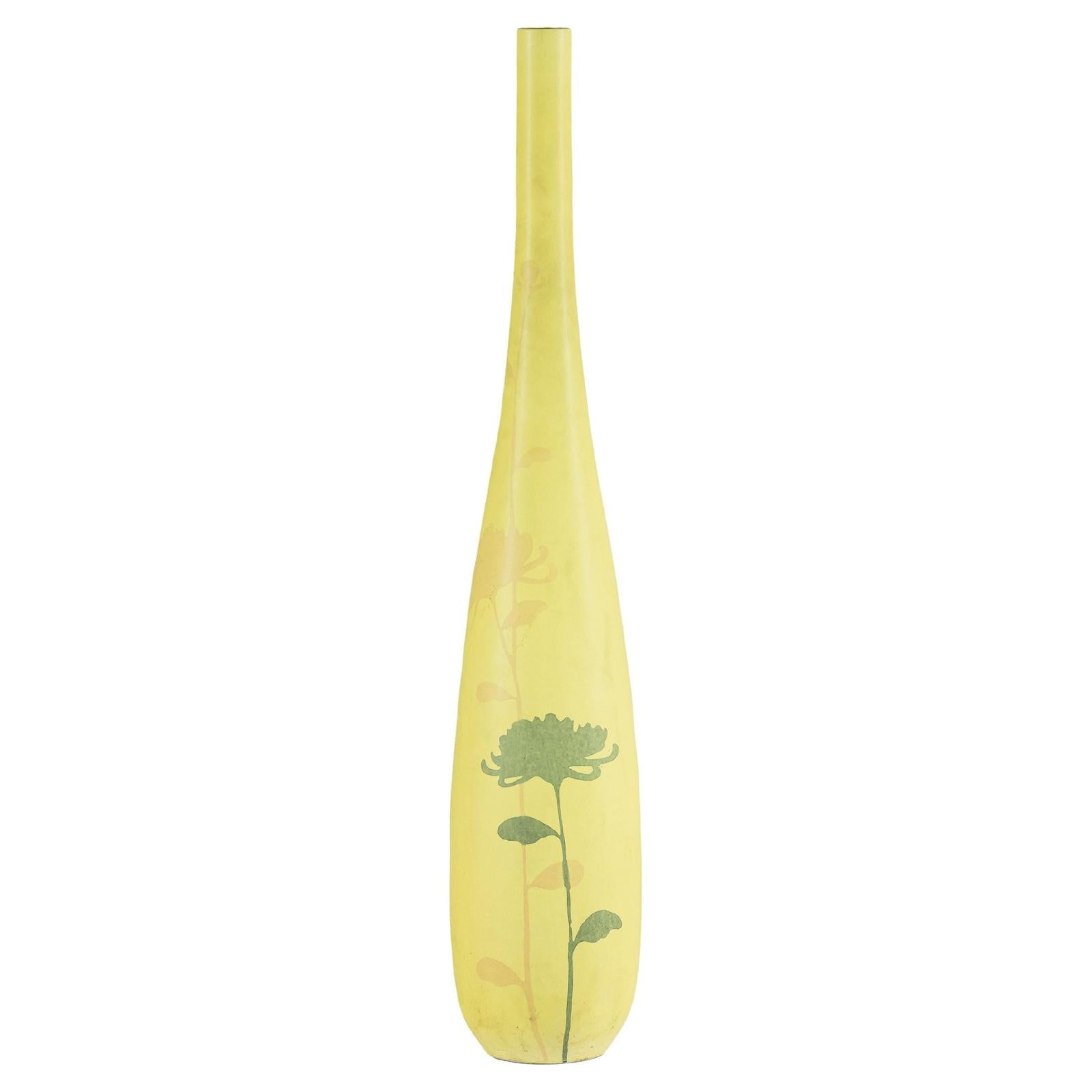 Yellow ceramic vase with hand-painted flowers near the base, tall and skinny, on a white background.