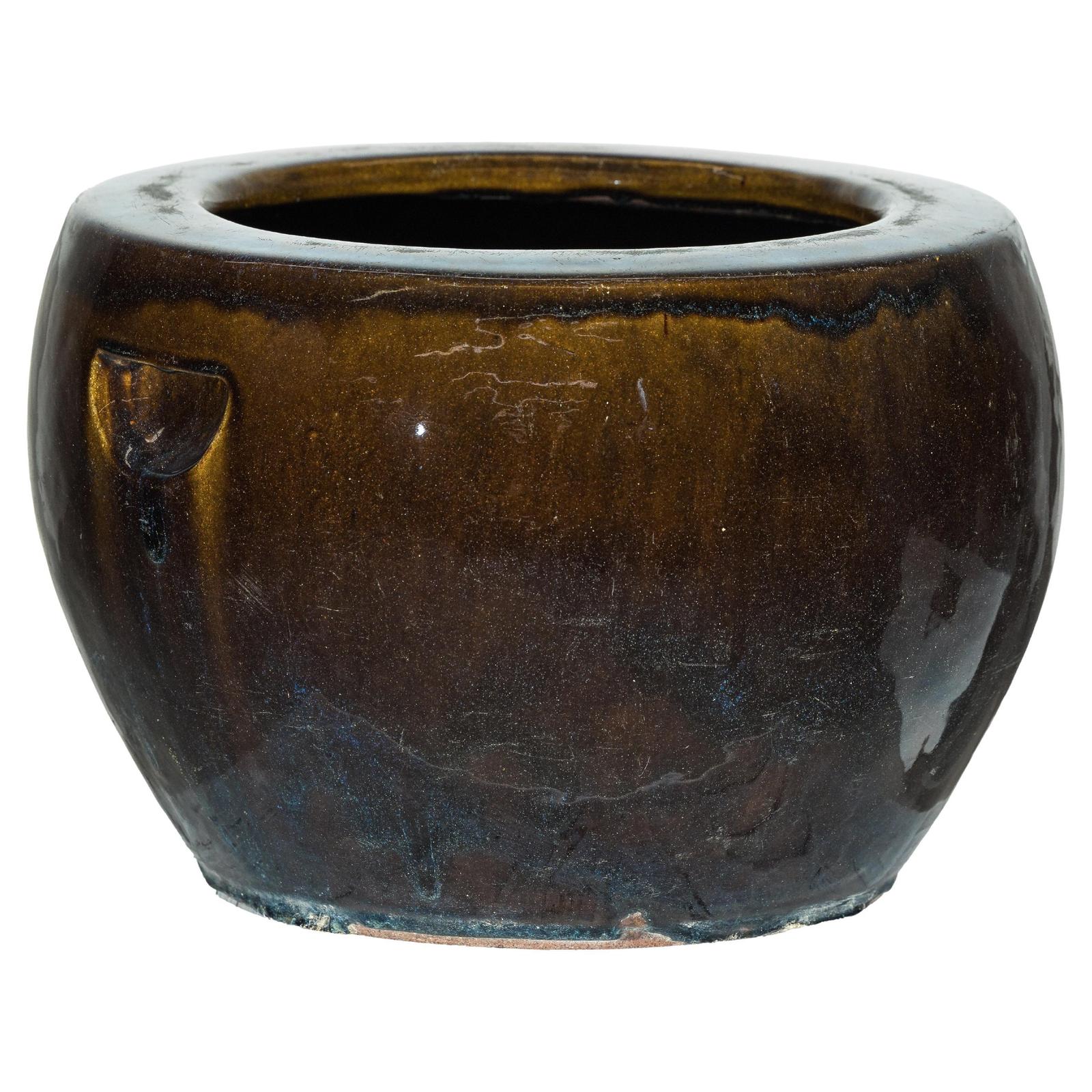 Brown and blue glazed ceramic planter with rounded shape and wide opening, glossy finish, on white background.