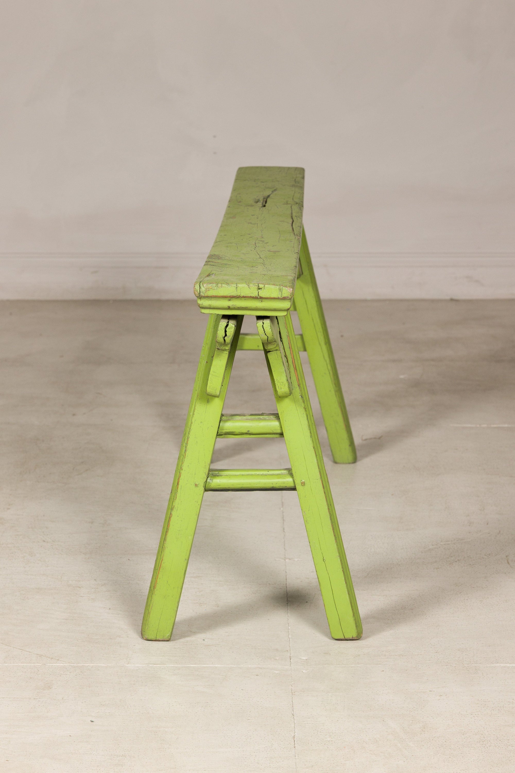 End view of green bench with A-frame supports