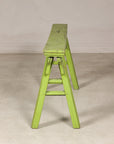 End view of green bench with A-frame supports